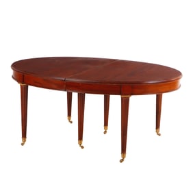 NINETEENTH CENTURY FRENCH OVAL MAHOGANY BRONZE MOUNTED DINING TABLE HAVING ONE MAHOGANY SKIRTED