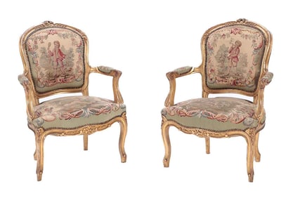 PAIR LOUIS XV STYLE CARVED AND GILT WOOD OPEN ARM CHAIRS C 1900.