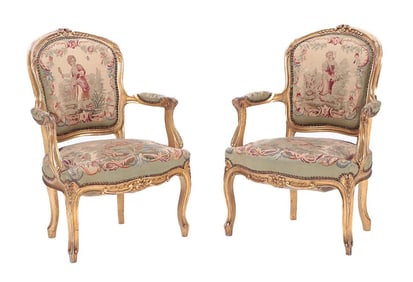 PAIR LOUIS XV STYLE CARVED AND GILT WOOD OPEN ARM CHAIRS C 1900.