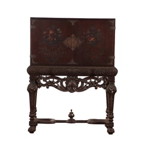 CARVED WALNUT CABINET C 1920 HAVING TWO PULL OUT TRAYS. THE CASE HAVING FLORAL PAINTINGS AND BRASS
