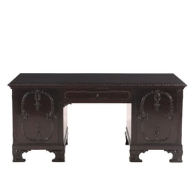 CHIPPENDALE STYLE MAHOGANY FLAT TOP DESK HAVING TWO DOORS OPENING TO SHELVES AND A DRAWER C 1910.