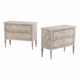 A pair of Italian Neo-Classical style painted and carved two drawer commodes C 1910 .