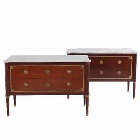 A pair of Louis XVI style marble top mahogany commodes signed Jansen C 1940 .