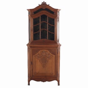 A Louis XV style oak vitrine cabinet in two parts from Belgium C 1900 .