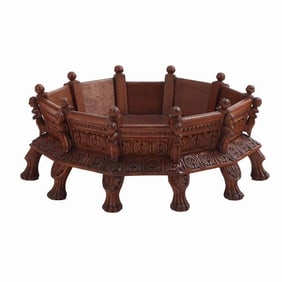 A hand carved hard wood dog or cat bed having figural decoration.