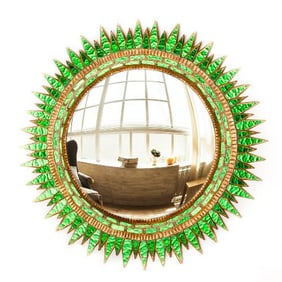 A large green glass convex sunburst mirror in the manner of Line Vautrin .