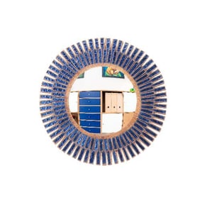A blue glass and resin convex mirror in the manner of Line Vautrin .