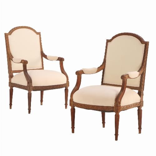 A Pair of French Louis XVI style carved open arm chairs C 1920.: A Pair of French Louis XVI style carved open arm chairs C 1920. This pair of perfect for your office, sitting room, or living room. The molded and carved wood frames are decorated throughout with a va