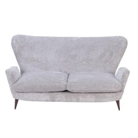 A stylish Italian wingback drop arm upholstered settee 20th C.