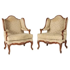 A pair of French Louis XV style carved bergeres C 1900.