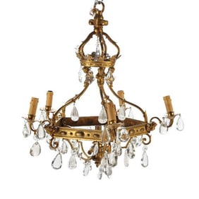 An antique French five-light bronze and crystal chandelier.