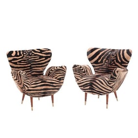 A pair of Italian wingback armchairs circa 1950.
