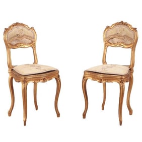 A pair of French Louis XV style giltwood side chairs C 1900.
