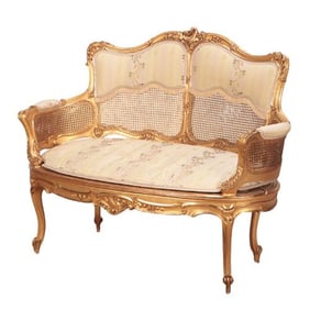 A French Louis XV style giltwood and carved settee C 1900.
