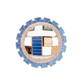 A blue glass and resin convex mirror in the manner of Line Vautrin .