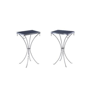 A pair of polished iron drinks tables .