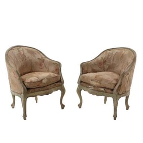 A pair of Italian rococo style painted and upholstered lounge chairs 19th C.