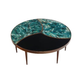 A three-part biomorphic marbleized glass and walnut circular coffee table.