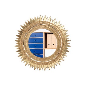 A gilt resin sunburst mirror in the manner of Line Vautrin .