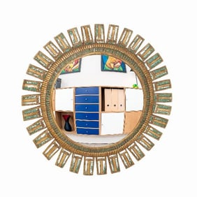 A large green glass and resin convex sunburst mirror in the manner of Line Vautrin .