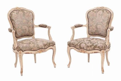 A pair of French Louis XV style painted and giltwood open armchairs C 1900.