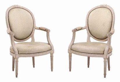 A pair of French Louis XVI style relief carved open armchairs C 1860.