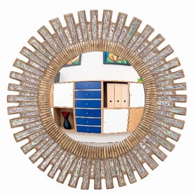 A blue ripple glass and resin geometric sunburst mirror in the manner of Line Vautrin .