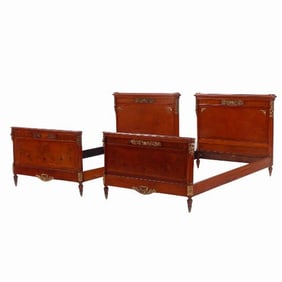 A pair of French Louis XVI style bronze mounted twin beds C 1920.