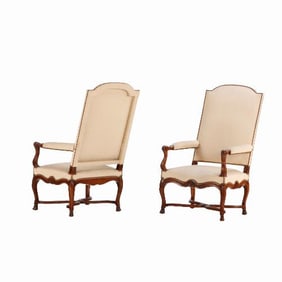 A pair of large scale French walnut open arm chairs C 1900.