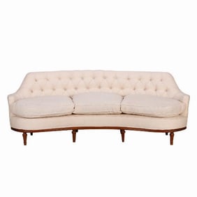 A classic luxurious tufted and curved back sofa C 1940.