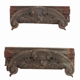 A pair of cast iron capitals with faces C 1890.