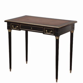 A French Louis XVI style ebonized mahogany leather-top petite writing desk C 1940 .