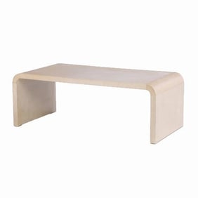 A parchment waterfall coffee table in the manner of Jean-Michel Frank .