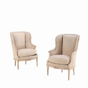 A pair of French Louis XVI style upholstered and painted bergere chairs C 1900.