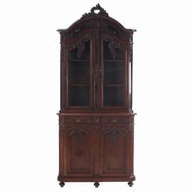 An ornately carved French walnut two-piece vitrine C 1880 of exceptionally high quality.