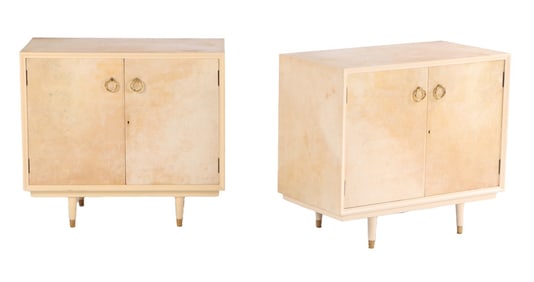 PAIR OF PARCHMENT COVERED TWO DOOR CABINETS C 1950 HAVING PAINTED LEGS.