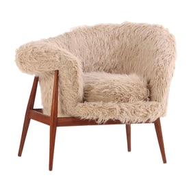 ASYMMETRIC LOUNGE CHAIR UPHOLSTERED IN FAUX SHEEP SKIN.