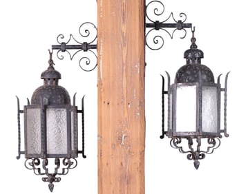 ONE OF THREE PAIRS OF FRENCH SIX SIDED WROUGHT IRON LANTERNS WITH BRACKETS HAVING TEXTURED GLASS