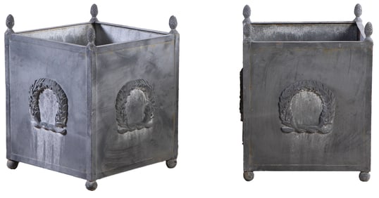 A PAIR OF IRON PLANTERS WITH LEAD WASH FINISH DECORATED WITH WREATHS AND PINEAPPLE FINIALS.