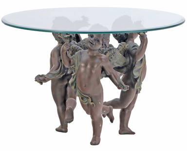 A BRONZE AND GLASS DANCING CHERUB COFFEE TABLE.: A bronze and glass dancing cherub coffee table. Ht: 24" Wd: 36" Dpth: 36"