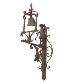 A LARGE IRON AND BRONZE ITALIAN WALL MOUNTED DOOR BELL DEPICTING A STANDING FIGURE ATOP A DRAGON
