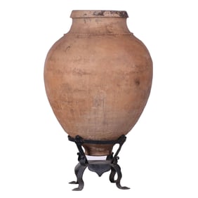 TERRACOTTA OLIVE JAR ON WROUGHT IRON BASE.