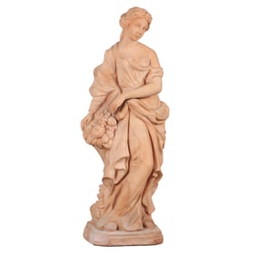 47" CLASSICAL ROBED TERRACOTTA FIGURE OF A FEMALE HOLDING A BASKET OF PROVISIONS.