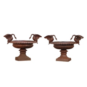 LARGE PAIR OF CAST IRON GARDEN URNS HAVING WINGED SWANS PERCHED ON THE RIMS.