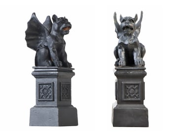 SMALL PAIR OF CAST IRON WINGED GRIFFINS RESTING ON DECORATED IRON BASES.