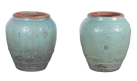 A PAIR OF GLAZED TERRACOTTA GARDEN PLANTERS HAVING GRAPE DECORATION.