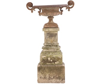 FRENCH NINETEENTH CENTURY CAST IRON GARDEN URN SITTING ATOP A STONE BASE.