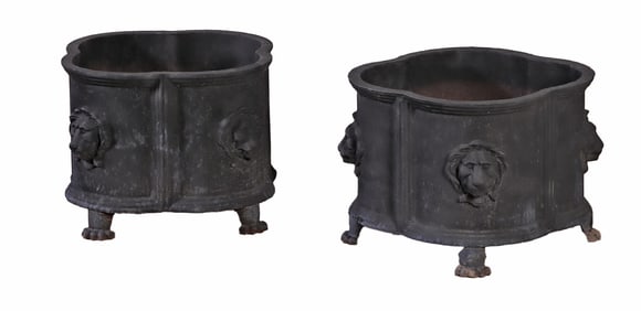 PAIR OF SHAPED CAST IRON FOOTED PLANTERS EACH HAVING FOUR LION MASKS.