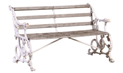 AN ENGLISH CAST IRON GARDEN BENCH HAVING WOOD SLAT SEATS AND BACK.