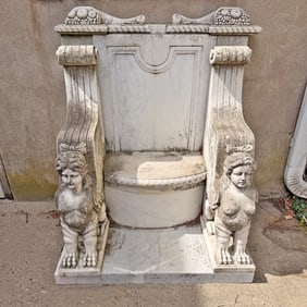 TALL CARVED MARBLE GARDEN BENCH HAVING CORNUCOPIA AND WINGED SPHINYX DECORATION.